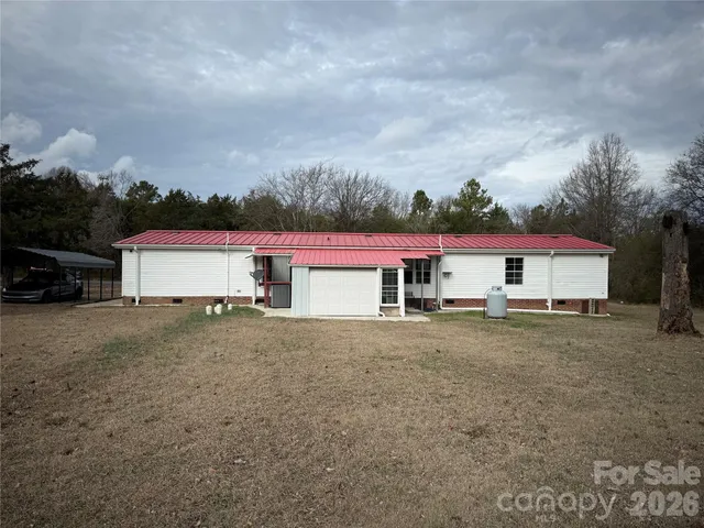 a view of a house with a yard and garage
