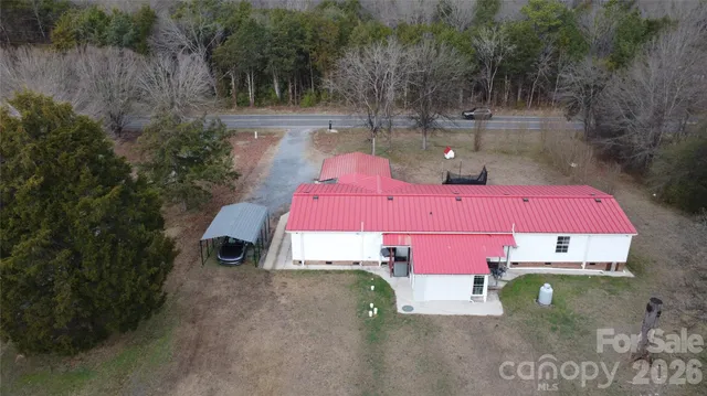 an aerial view of a houses with yard