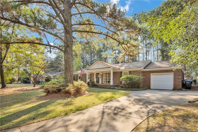 a front view of a house with a yard garage and outdoor seating