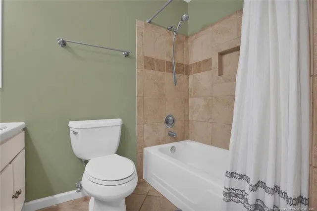 a white toilet sitting next to a bath tub