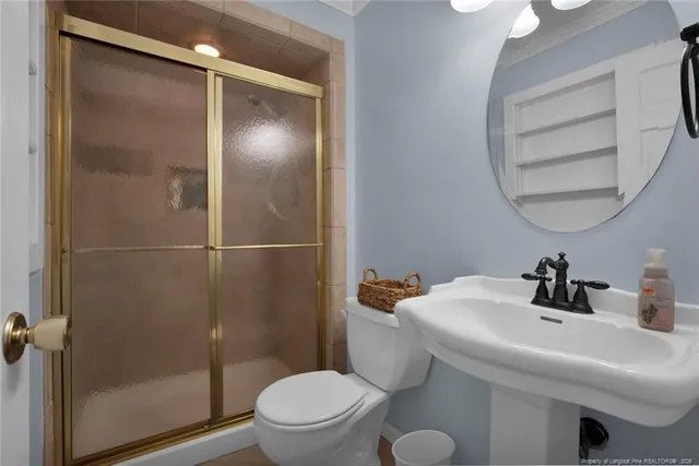 a bathroom with a sink toilet and shower