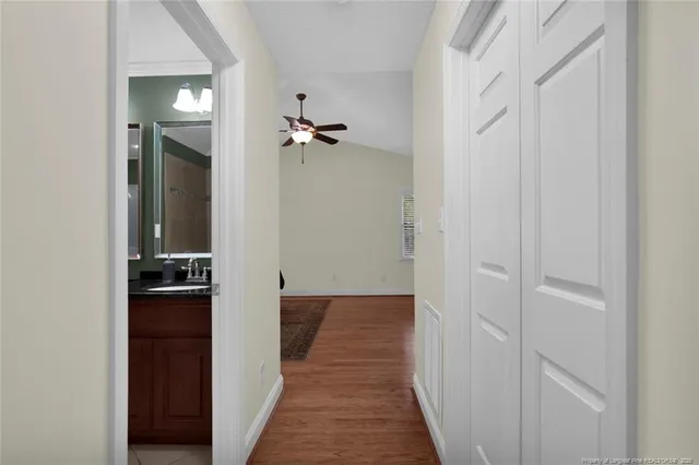 a view of a hallway with wooden floor