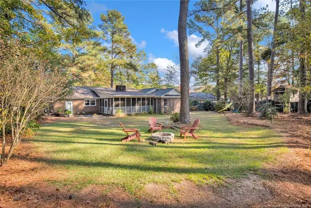 a front view of house with yard and swimming pool