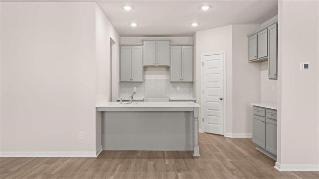 319 Tate Street Monroe, GA 30655 - Photo 12 of 33 a view of a kitchen with wooden floor