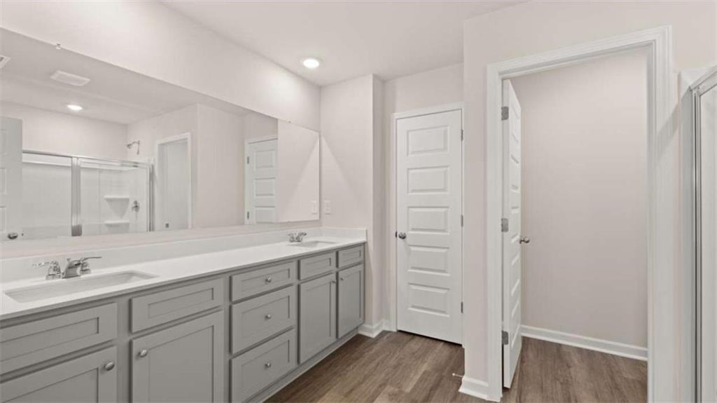 319 Tate Street Monroe, GA 30655 - Photo 26 of 33 a spacious bathroom with a double vanity sink a mirror and a bathtub