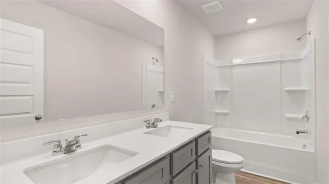 a bathroom with a sink shower bathtub and a toilet