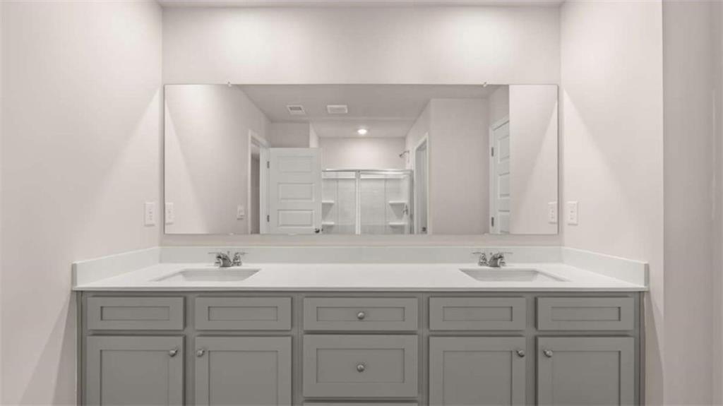 319 Tate Street Monroe, GA 30655 - Photo 27 of 33 a bathroom with double sink and a mirror