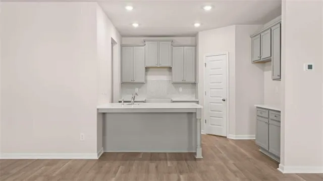 a view of a kitchen with wooden floor
