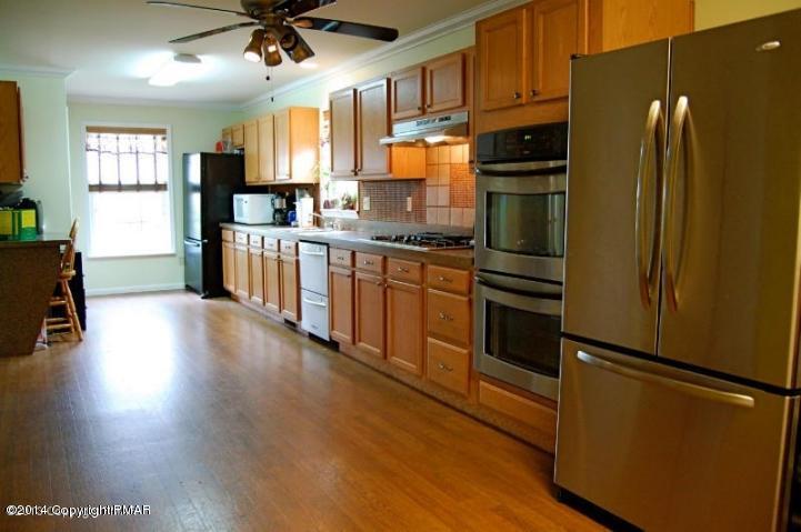 117 Michaels Run Road Stroudsburg, PA 18360 - Photo 2 of 15 a kitchen with stainless steel appliances a refrigerator and wooden floor