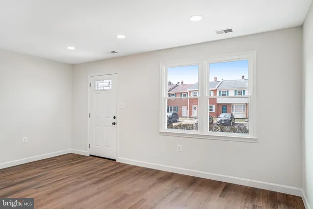 a view of a room with wooden floor and cabinet