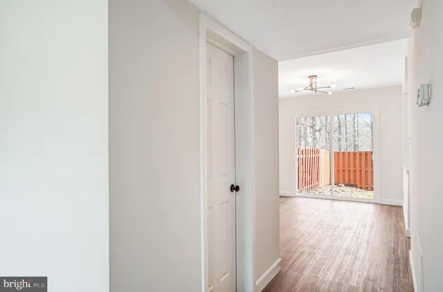 a view of a room with wooden floor and windows