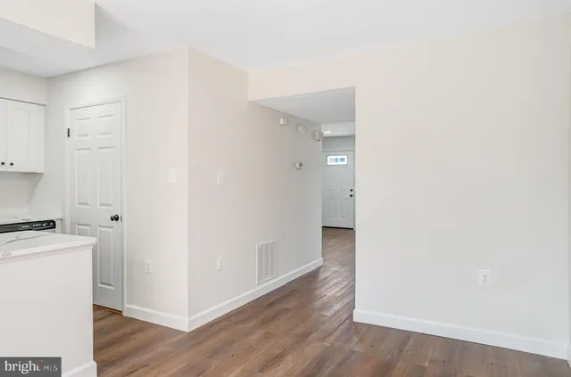 a view of a kitchen with wooden floor