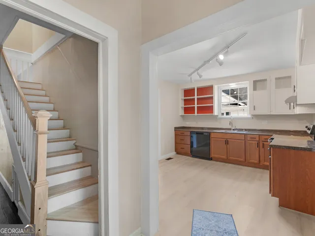 a kitchen with stainless steel appliances a sink and a refrigerator