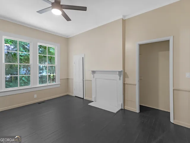 an empty room with windows and closet