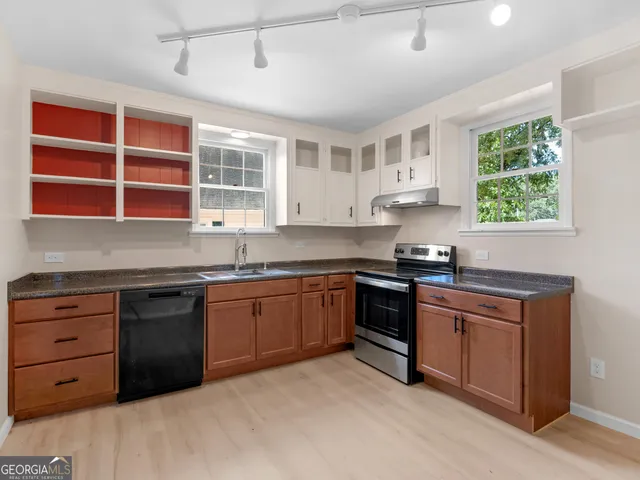 a kitchen with stainless steel appliances granite countertop a stove and a sink