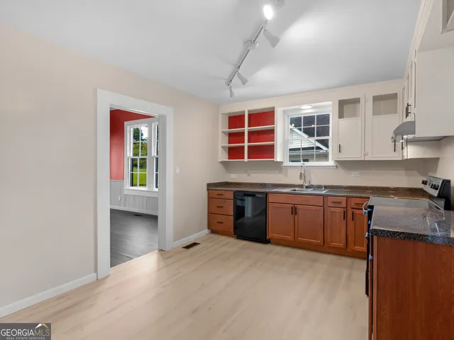 a kitchen with stainless steel appliances granite countertop a stove sink and cabinets