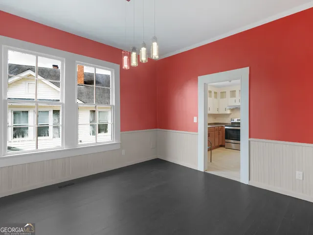 an empty room with a empty space and windows