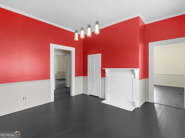a view of a livingroom with wooden floor and chandelier