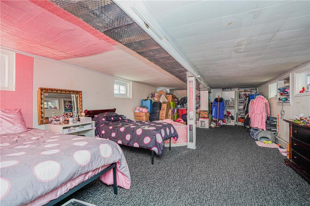 1764 East 24th Street Brooklyn, NY 11229 - Photo 12 of 16 a bed room with furniture and a baby bed