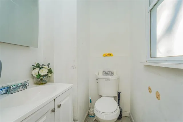a bathroom with a sink a toilet and a window