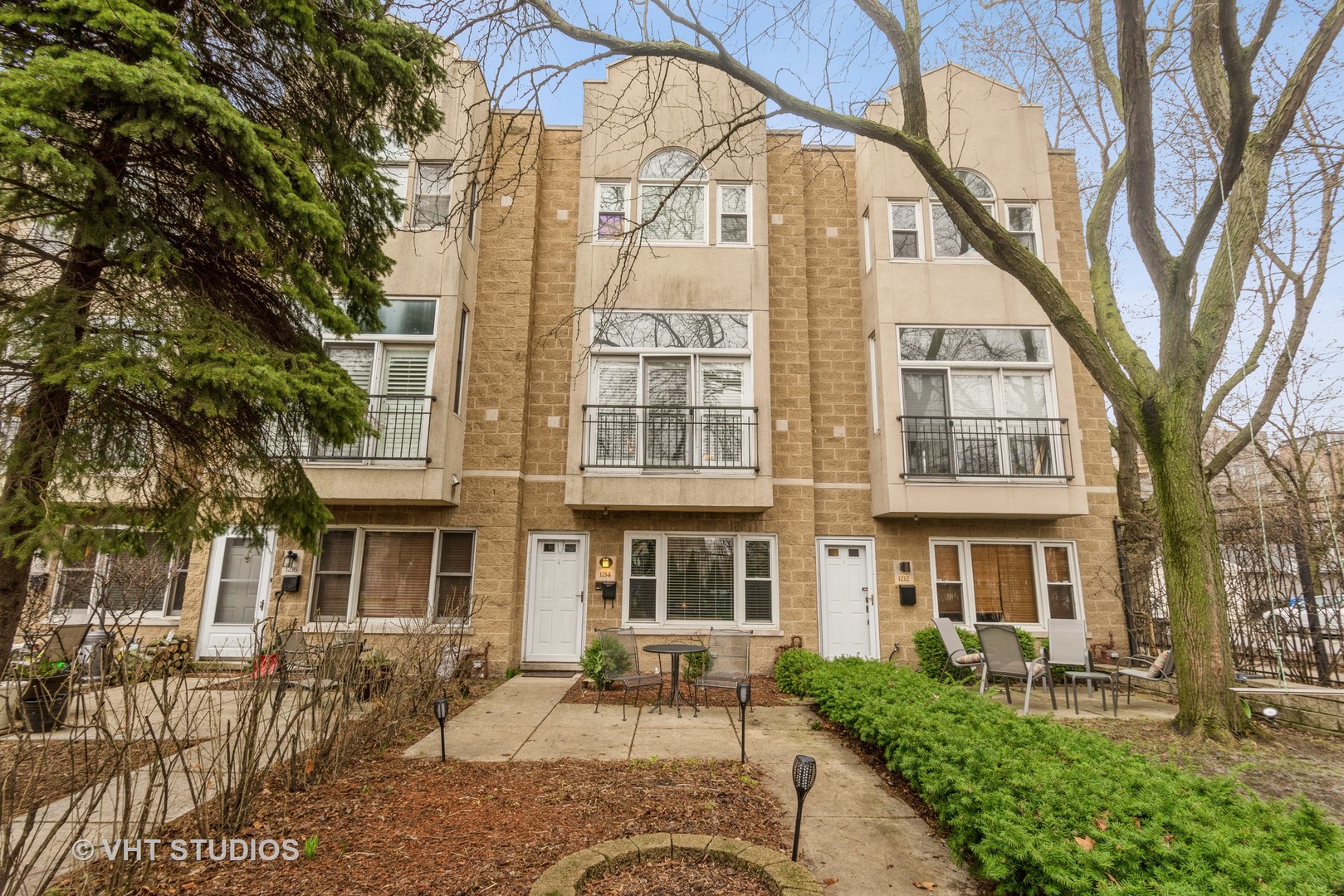 a front view of a residential apartment building with a yard