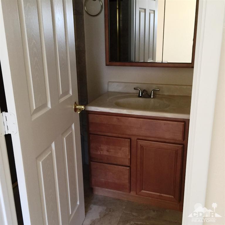67665 Paletero Road Cathedral City, CA 92234 - Photo 13 of 18 a bathroom with a sink and a mirror