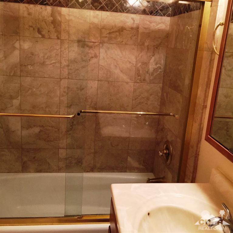 67665 Paletero Road Cathedral City, CA 92234 - Photo 14 of 18 a bathroom with a bathtub and shower