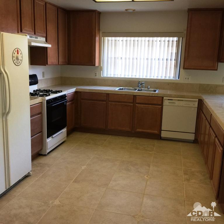 67665 Paletero Road Cathedral City, CA 92234 - Photo 7 of 18 a kitchen with a sink stove and microwave