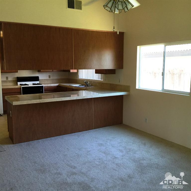 67665 Paletero Road Cathedral City, CA 92234 - Photo 8 of 18 a kitchen with a sink and a stove