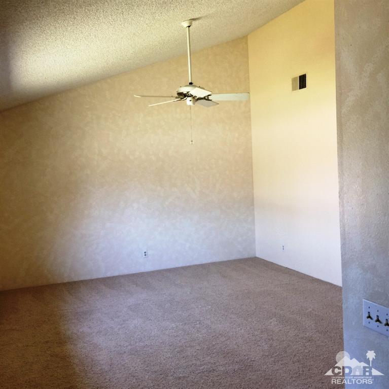 67665 Paletero Road Cathedral City, CA 92234 - Photo 9 of 18 an empty room with a ceiling fan
