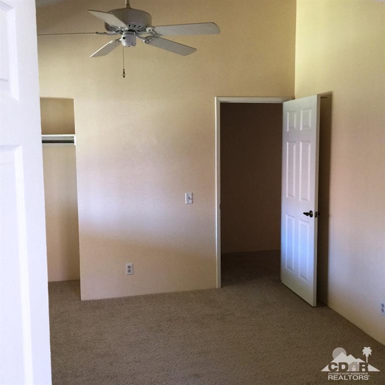 67665 Paletero Road Cathedral City, CA 92234 - Photo 10 of 18 an empty room with closet and a chandelier fan