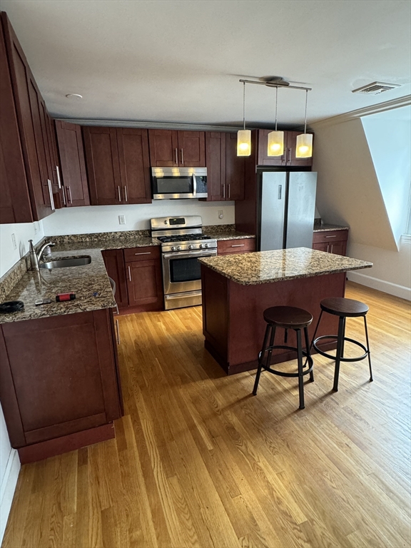 1798 Beacon Street, Unit 3 Brookline, MA 02445 - Photo 1 of 1 a kitchen with stainless steel appliances granite countertop a stove a sink dishwasher a microwave oven with granite countertops and cabinets