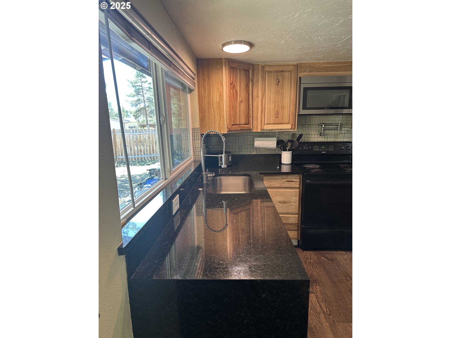136010 Hwy 97 Crescent Crescent, OR 97733 - Photo 11 of 43 a living room with large window and cabinets
