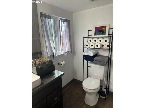 a bathroom with a toilet a sink and a window