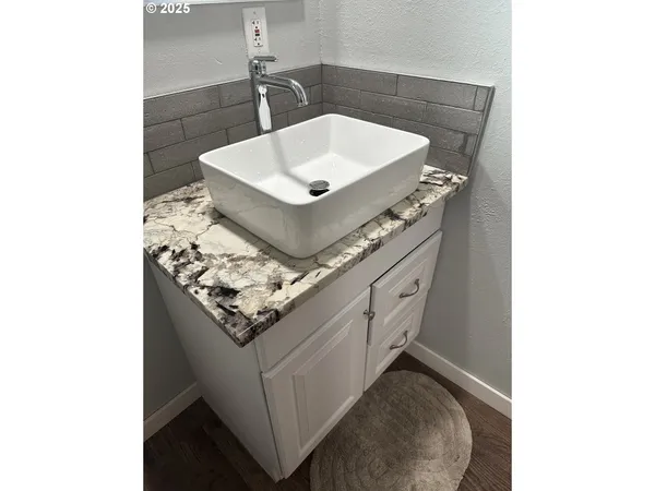 a bathroom with a sink and a mirror