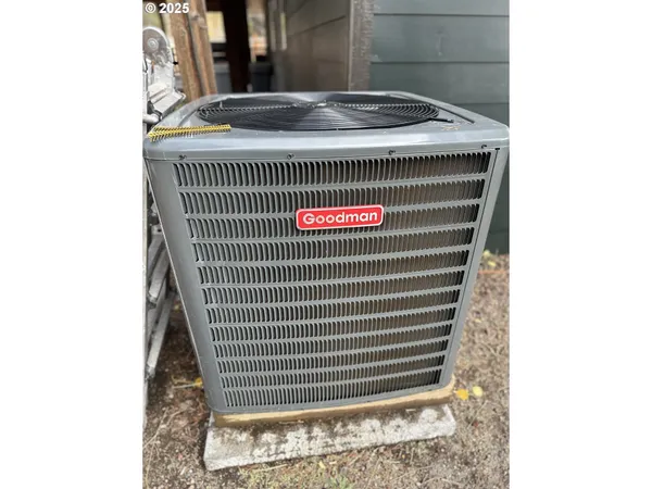 a backyard of a house with barbeque oven and brick wall