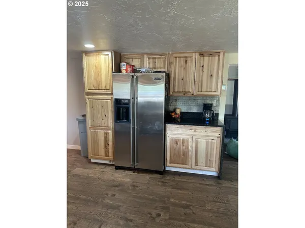 a kitchen with stainless steel appliances a refrigerator and a stove