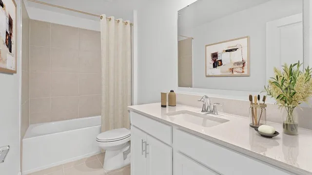 a bathroom with a granite countertop sink a toilet and a bathtub