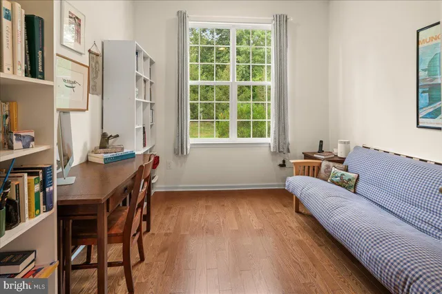 a bedroom with furniture and a large window