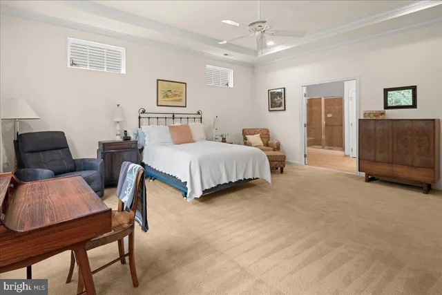 a spacious bedroom with a bed and dresser