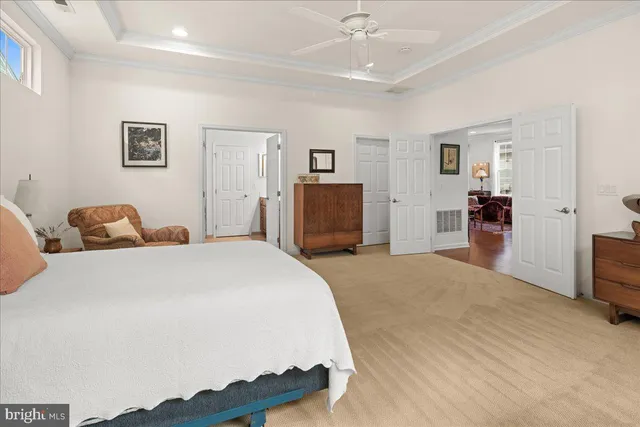 a large bedroom with a bed and large windows