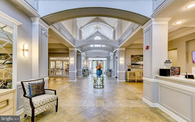 a living room with furniture kitchen view and a large window