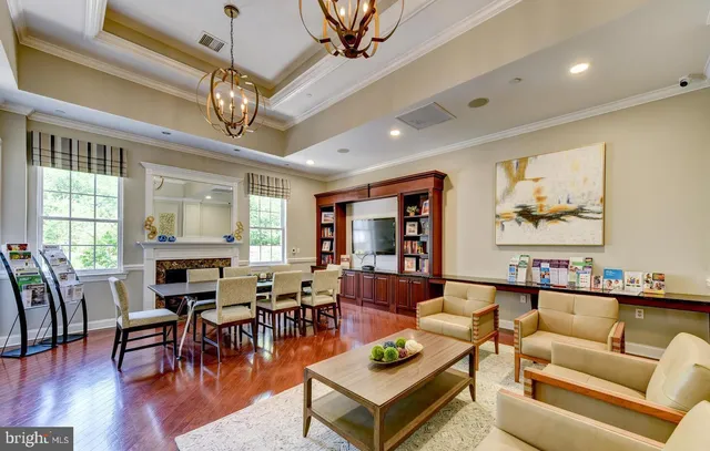 a living room with furniture a table and a chandelier