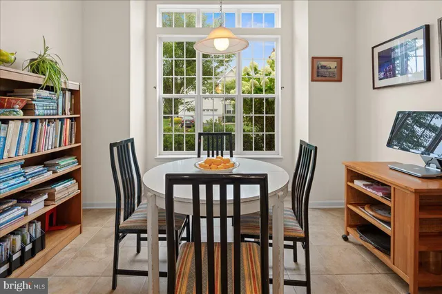 a view of a dining room with furniture and a potted plant