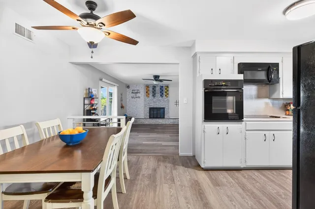 a kitchen with granite countertop a refrigerator and a stove