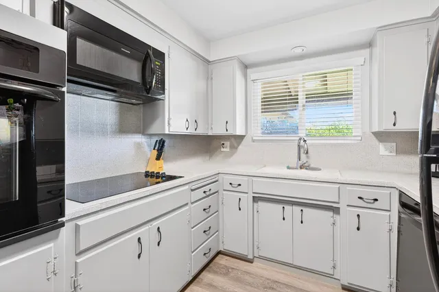 a kitchen with appliances cabinets and a sink