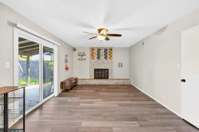 an empty room with fireplace and windows