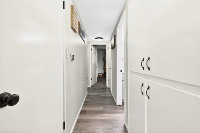 a bathroom with a sink a toilet a mirror and shower curtain