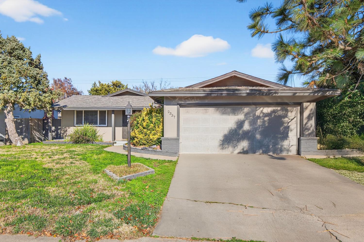 2337 Corbin Lane Lodi, CA 95242 - Photo 2 of 34 a front view of a house with a yard and potted plants