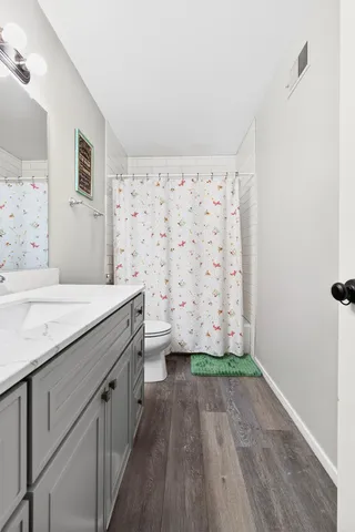 a bathroom with a sink and mirror with toilet